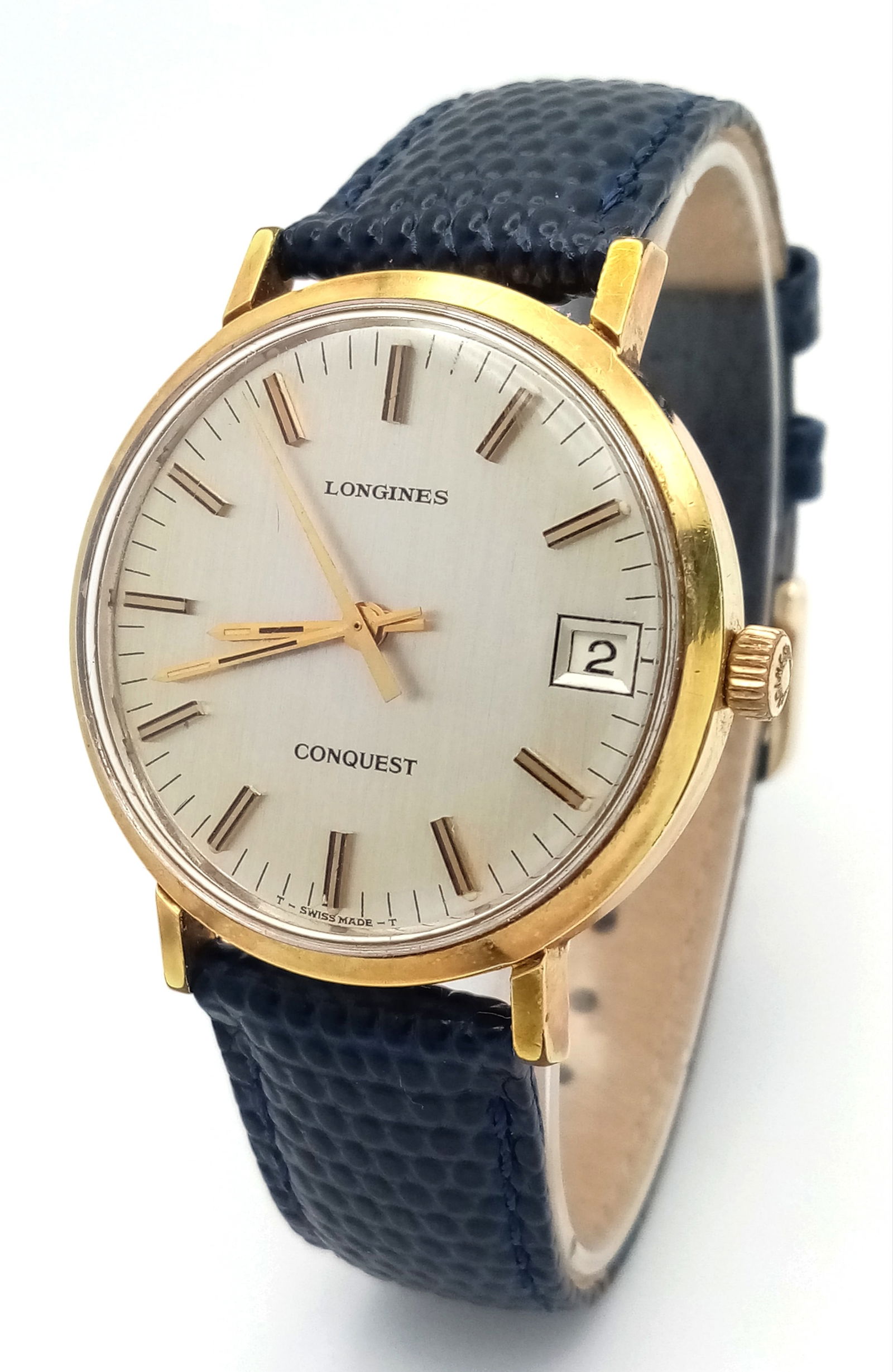 A Vintage Longine Mechanical Gents Watch. Blue leather strap. Gilded stainless steel case - 36mm.: A Vintage Longine Mechanical Gents Watch. Blue leather strap. Gilded stainless steel case - 36mm. Silver tone dial with date window. In working order. Comes with original case.
