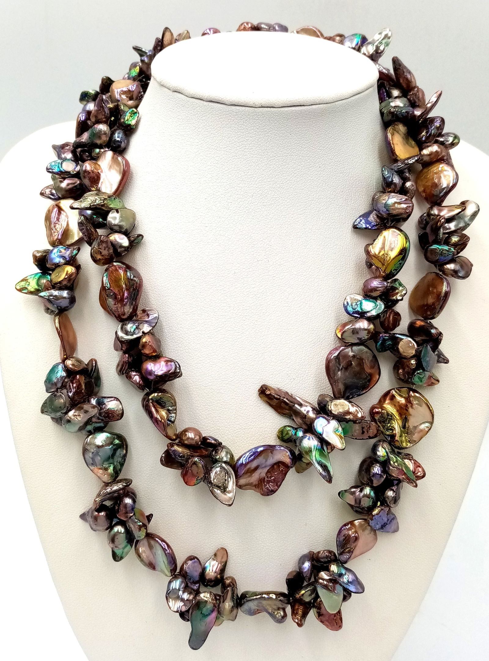 A striking matinee length pearl shell necklace. Featuring iridescent abalone shell pieces: A striking matinee length pearl shell necklace. Featuring iridescent abalone shell pieces throughout. Approx 86cm in length. Please see photos for details.
