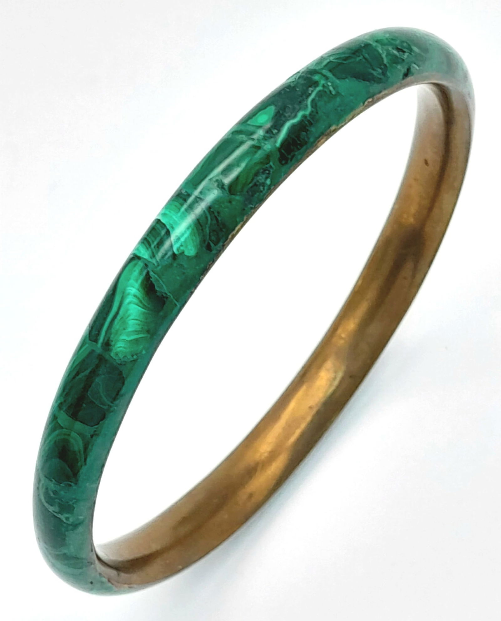 A malachite enamel bangle. A hinged bronze-tone bracelet decorated with green malachite enamel.: A malachite enamel bangle. A hinged bronze-tone bracelet decorated with green malachite enamel. Approx. 7cm internal diameter.