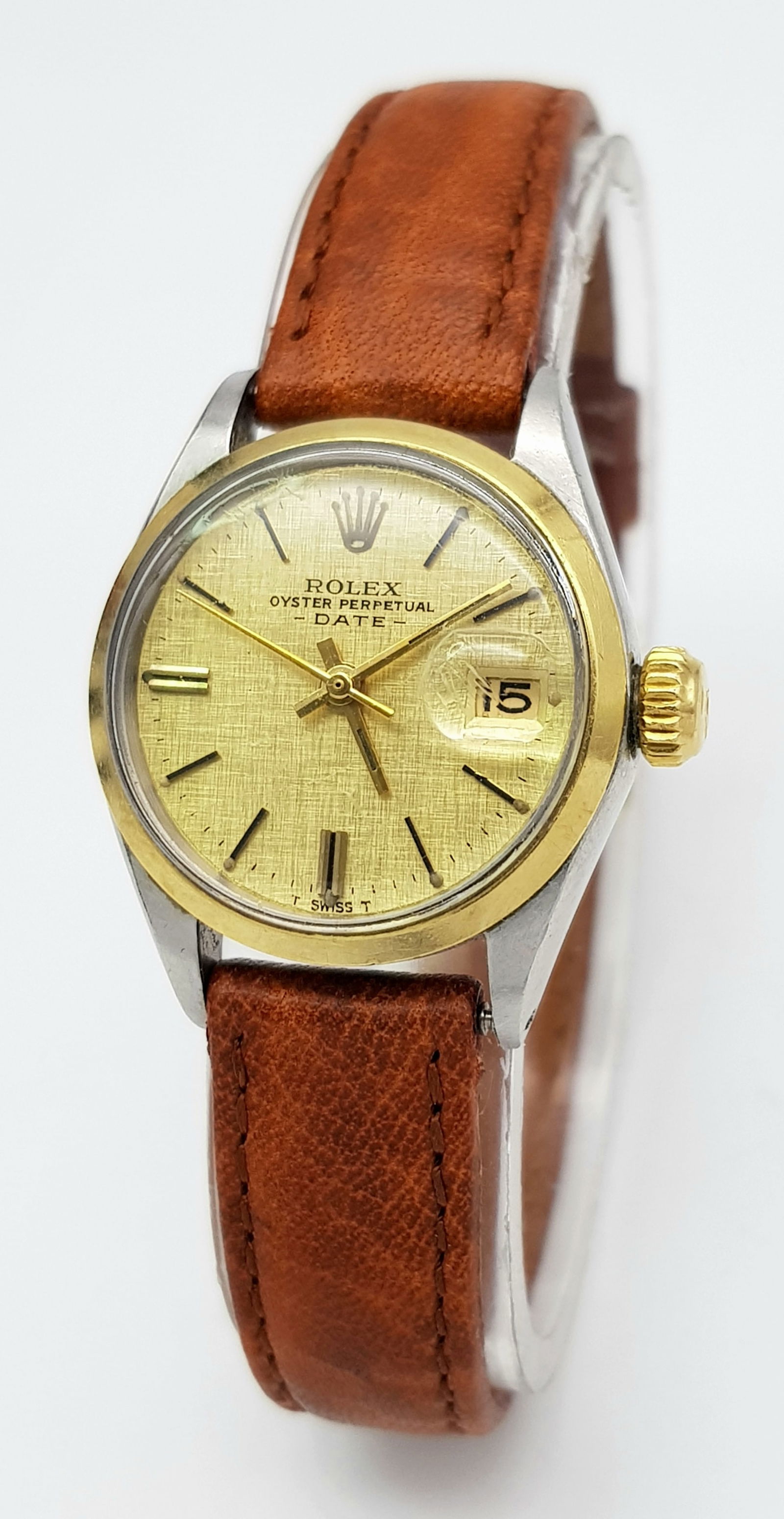 A LADIES ROLEX WATCH WITH THE FABULOUS GOLDEN LINEN DIAL AND TAN LEATHER STRAP . COMING IN THE: A LADIES ROLEX WATCH WITH THE FABULOUS GOLDEN LINEN DIAL AND TAN LEATHER STRAP . COMING IN THE ORIGINAL BOX .