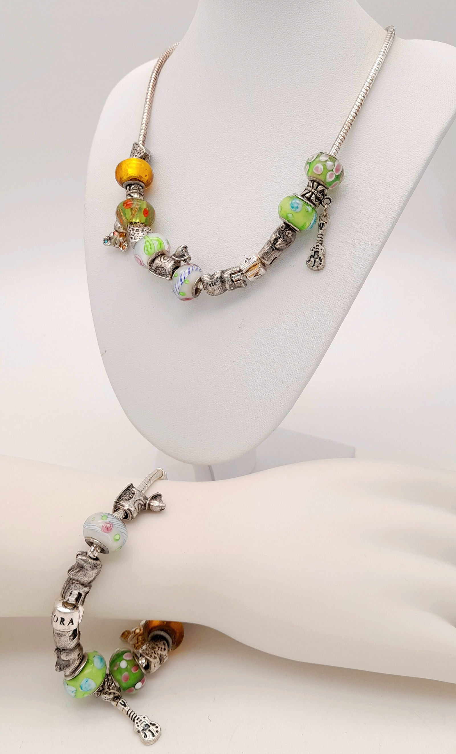 A matching set of multi charms decorative necklace and bracelet. Total length 47 and 22 cm. Please: A matching set of multi charms decorative necklace and bracelet. Total length 47 and 22 cm. Please see photos for details.