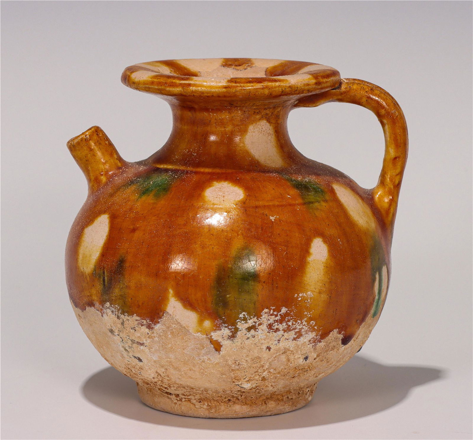 A Chinese Dangyang-Type Sancai Glazed Pottery Flagon: A Chinese Dangyang-Type Sancai Glazed Pottery Flagon Height: 3.9 inches. Width: 3.7 inches. Height: 10cm Width: 9.5cm