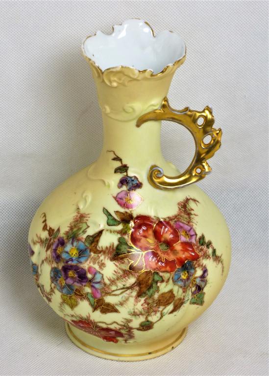 Antique Rudolstadt Handled Vase/ Ewer: Rudolstadt Handled Vase/ Ewer with Hand Painted Flower Design. Made in Germany. First part of 20th Century. Measures 8" Tall. Condition:Good, minor wear to gold trim