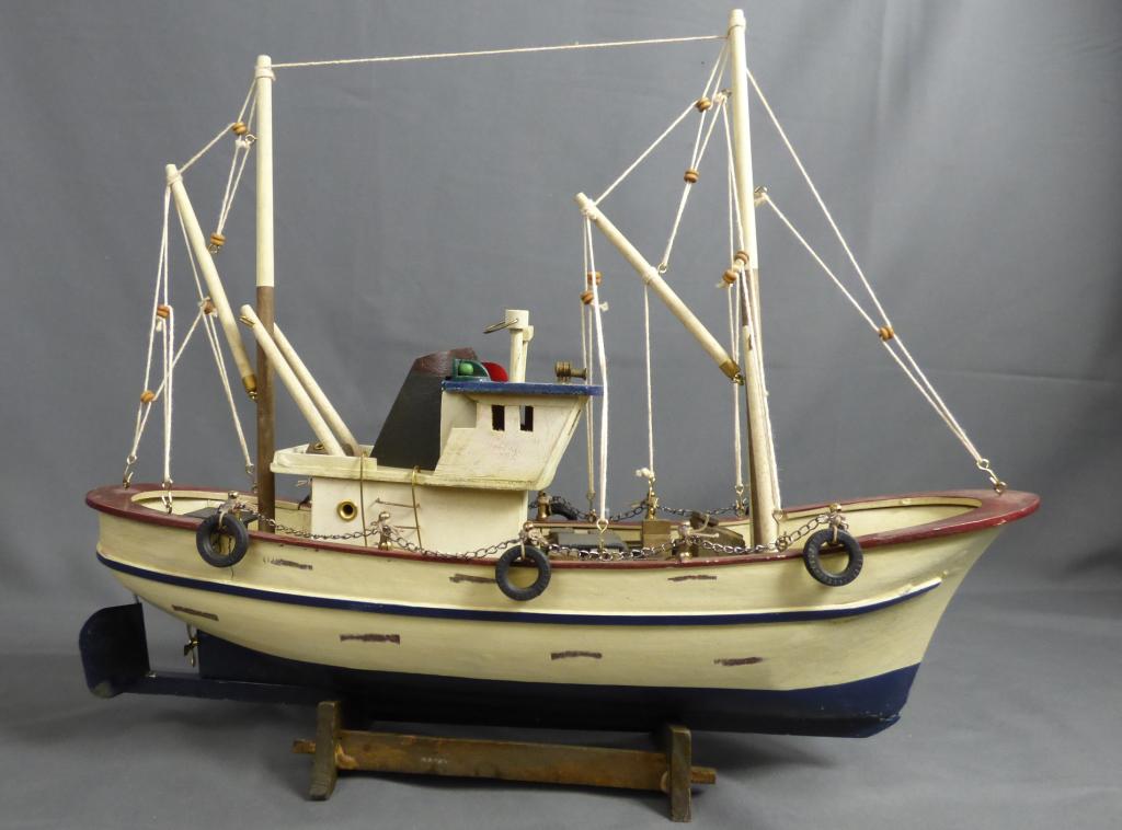 Wood Carved Fishing Boat Model: Wood Carved Fishing Boat Model. Measures 13 1/2" x 14". Condition: Good, snall crack on wood on one side