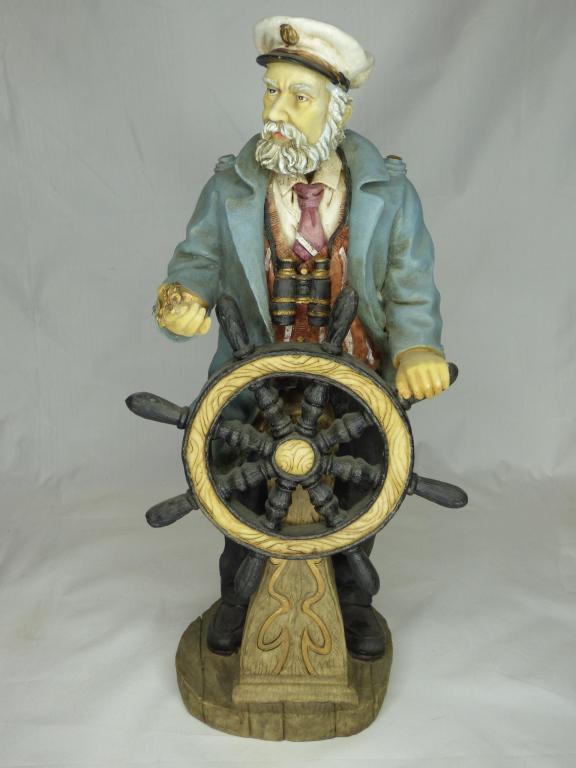 Sea Captain with Ship Wheel Sculpture: Sea Captain with Compass and Ship Wheel Sculpture. Measures 19" tall. Condition: Good