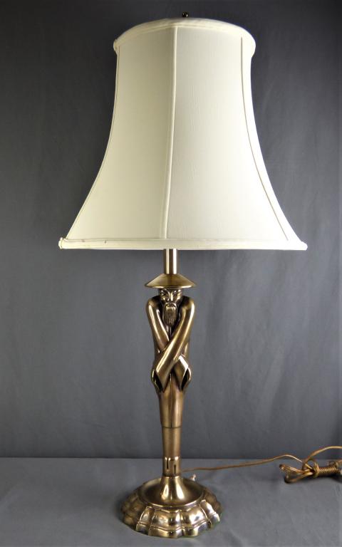 Viktor Schreckengost "Chinaman" Deco Style Lamp: Viktor Schreckengost (1906-2008, American). "Chinaman" Tabletop Polished Brass Lamp designed for Colonial Premier Lamp Co. Comes with Original Glass Shade and Original Fabric Shade. Measures 35" tall.