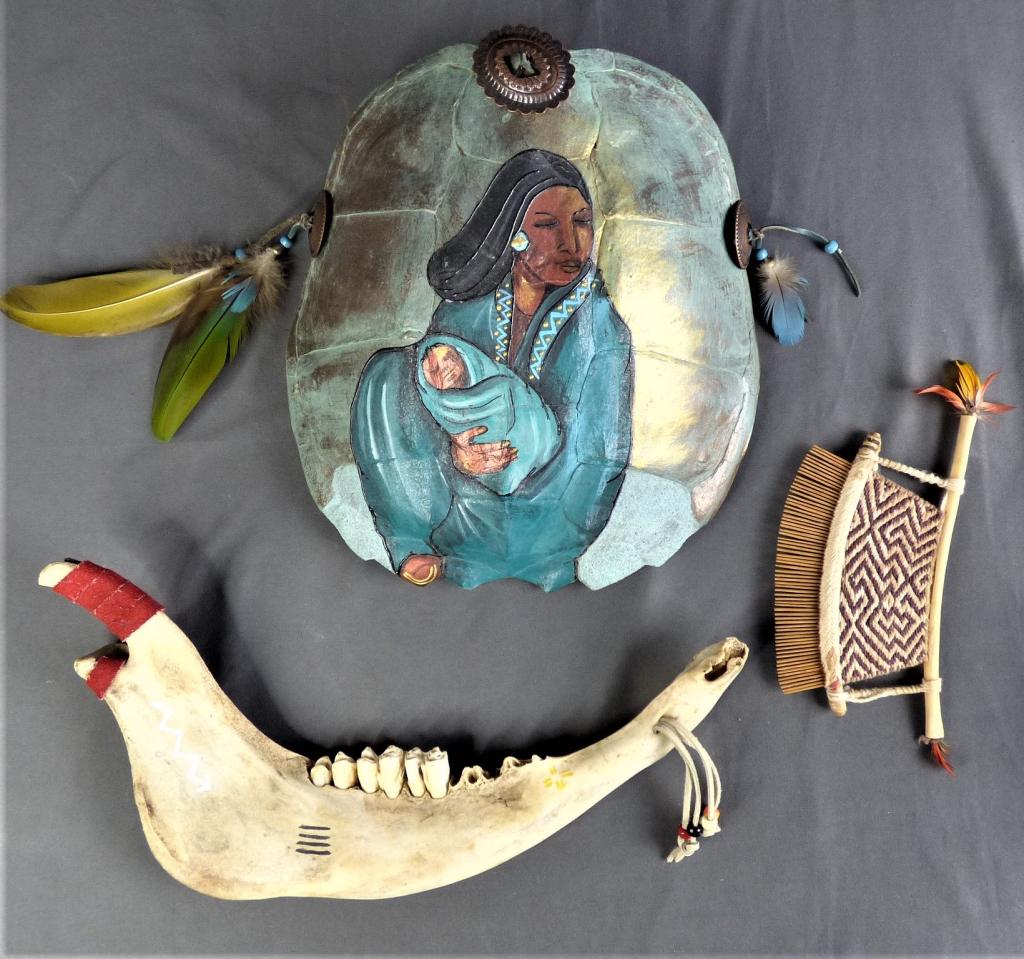 Native AMerican Indian Art- Turtle Shell Painting: Native American Indian Art- Painting of Mother and Child on Turtle Shell; Bone and Wood Comb; Cow Jaw. Shell is 12" x 10"; Comb is 7 1/2" x 4"; Jaw is 15" x 7". Condition: Good