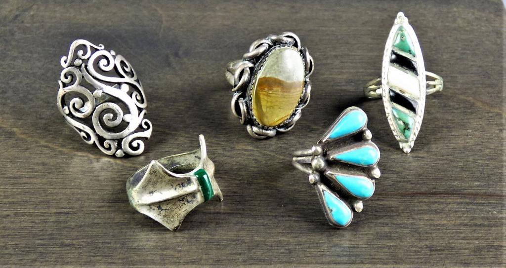 Native American Sterling Silver Rings: Lot of five Native American Sterling Silver rings. Includes turquoise, jasper, malachite, and what looks to be onyx and quartz. All are in good vintage condition.