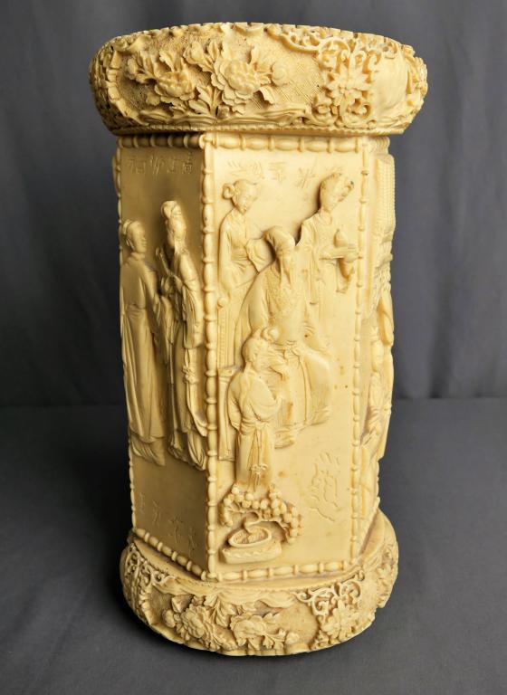 Large Vintage Chinese Carved Figural Vase: Large (14" tall & 7.5" dia) ivory colored faux bone umbrella holder / vase. Carved figural iages of people and flowers/ various scenes including some fighting, market, and traditional images. In great