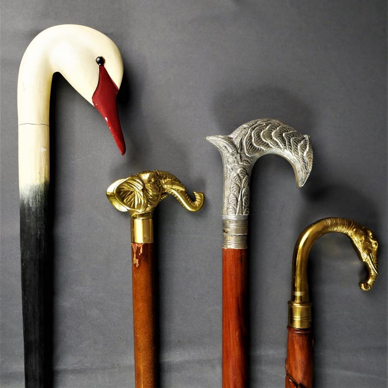 Animal Head Carved Walking Sticks/ Canes: Lot of four animal themed / floral canes. Includes two wood canes with brass elephant handles, as well as a wood cane with a goose's head as the handle and a nicely detailed wood cane with an engraved