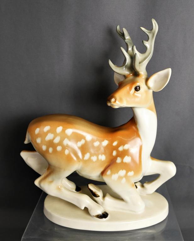 LFZ Lomonosov Porcelain Stag / Deer Figurine: Lovely porcelain dappled buck figurine by Lomonosov (made in USSR). He stands 11 3/8" by 9 3/4". He is in the process of lying down and his movement is captured so beautifully by the makers. Excellent