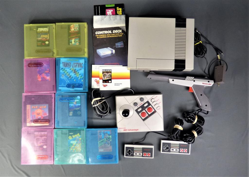 Nintendo NES NES-001 Console, Games, Controlers: Original 1985 Nintendo Entertainment System NES NES-001 Console with two controlers, gun, NES Adventage Controler, manuals and Games. Games are Pac-Man, Mario Pinball, Q-bert; Donkey Kong Classics; Th