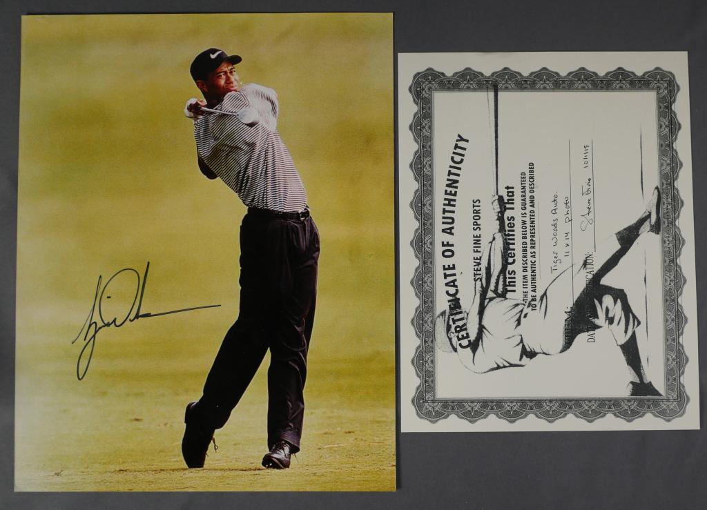 Tiger Woods Autographed/ Signed Golf Photograph: Tiger Woods Autographed/ Signed 11" x 14" Golf Photograph. Comes with Certificate of Authenticity. Condition: Good. We truly believe that this item is authentic, but Esquis Auctions does not have spec