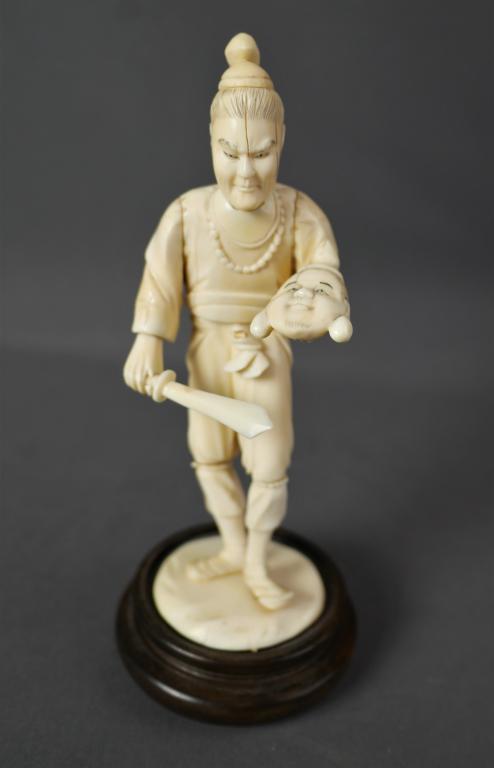 Antique Japanese Bone Carved Figurine Man w/ Sword: Early 20th Century Japanese Ixvory Bone Carved Figurine of Man with Sword- most likely Kabuki Theater actor. Measures 7 1/2" tall. Good overall condition, natural cracks on mans head.