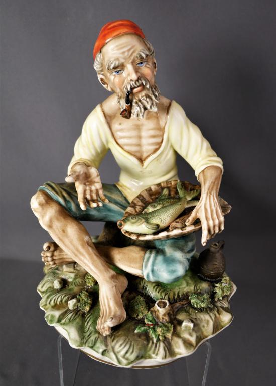 Capodimonte Fisherman Italian Porcelain Figurine: Capodimonte Fisherman Italian Porcelain Figurine. Measures 11" x 8" x 8". Good Condition.