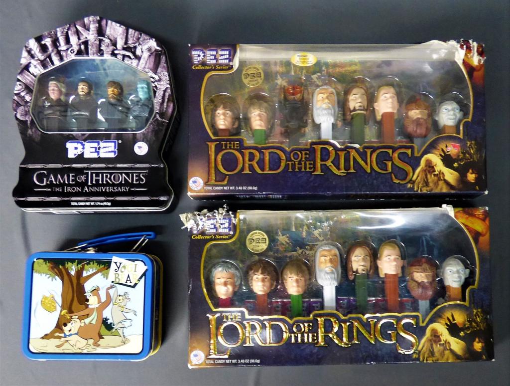 Lord of the Rings & Game of Thrones PEZ Candy Disp: Two Sets of The Lord of the Rings and one Game of Thrones Iron Anniversary PEZ Candy Dispeser Sets. Lot comes with Yogi Bear Mini Lunch Box. Both Lord of the Rings Sets have dog bites at the corners o