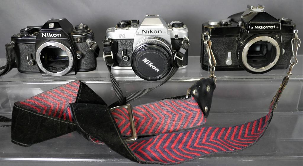 3 Vintage Nikon Film Cameras: 3 Vintage Nikon Film Cameras- Nikon EM (body only); Nikon Nikkormat (Body Only) and Nikon FG with 50mm 1:1.8 Lens. Good overall condition showing some age related wear, untested.