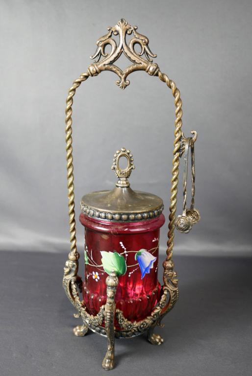 Antique James W. Tufts Silver Plated Pickle Castor: Antique Victorian James W. Tufts Silver Plated Pickle Castor with hand painted crandberry glass jar and sterling silver Tongues. 13" x 5" x 5". Good Condition.