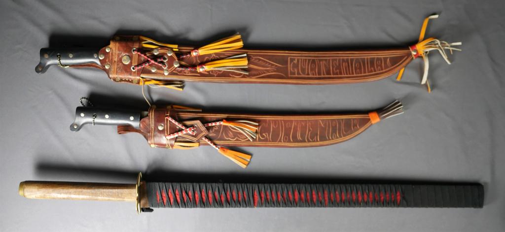 Japanese Sword & Calima Machete: Japanese Sword Replica and two Calima Machete from Guatemala. Measure 26"- 37" long. Good Condition.