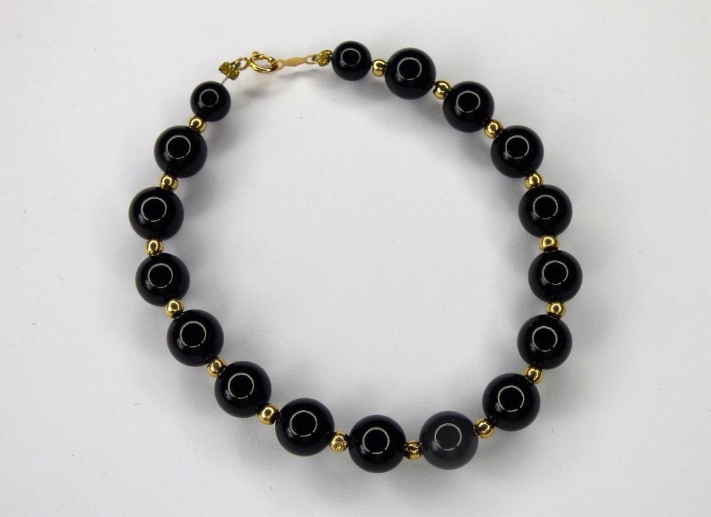 14k Gold Bracelet with Black Onyx Beads: Black Onyx Beads Bracelet with 14k Gold Beads and Clasps. Measures 7" long. Good Condition.
