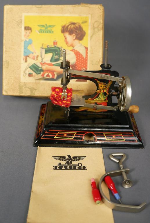 1940's German Casige #121 Toy Sewing Machine: 1940's German Casige #121 Fairy Tales Toy Sewing Machine in Original Box. Good Overall Condition.