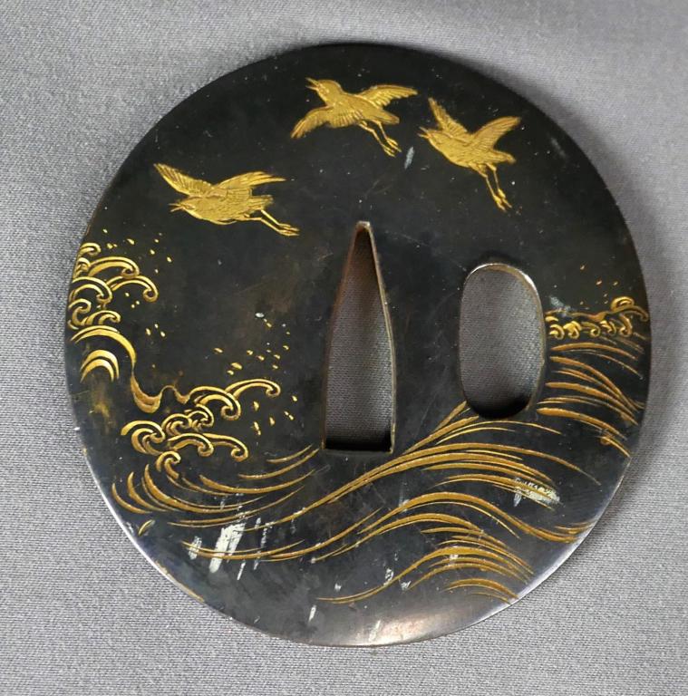 Antique Tsuba Samurai Sword Guard w/ Flying Birds: Antique Tsuba Samurai Sword Guard. Engraved with waves and flying birds and inlaid in gold. Approx. 0.3" in diameter. Good Condition with some scuffs.