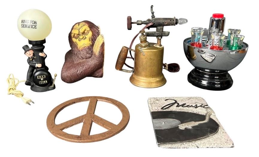 Man Cave Collectibles- Vodka Dispenser; Bar Lamp,: Group of Man Cave Collectibles. Vodka Dispenser with shot glasses; Figural Drunk Man Bar Lamp; Table Lamp made of Antique Blow Torch; Yetti Wall Plaque; Music Wall Plaque; Cast Metal Peace Sign. All a