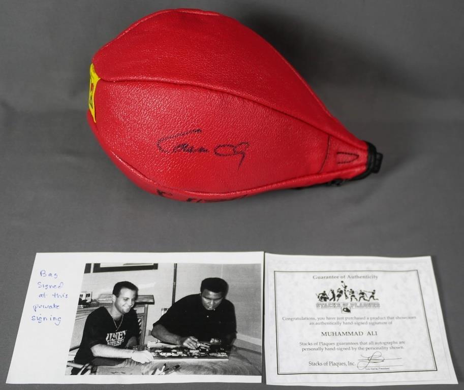 Muhammad Ali Autographed/ Signed Punching Bag: "Cassius Clay" aka Muhammad Ali Signed/ Autographed Everlast Red Leather Punching Bag. Comes with Certificate of Authenticity. Condition: Good. We truly believe that this item is authentic, but Esquis