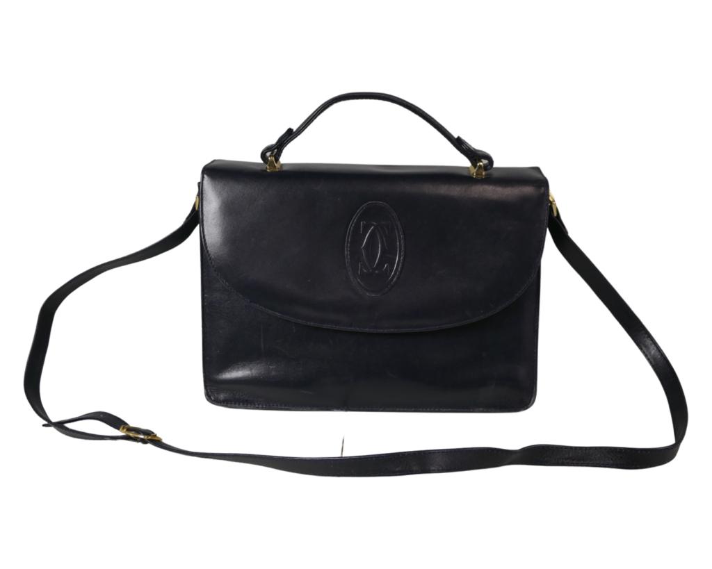 Cartier Ladies Black Leather Handbag/ Purse: Cartier Ladies Black Leather Handbag/ Purse. 11" x 8 1/2" x 5". Good Condition. Esquis Auction does not have specialists on designer purses and handbags and we can not guarantee authenticity of these 