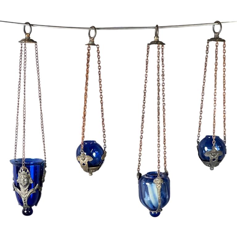 Group of Antique Hanging Vigil Lamps w/ Cherubs: Lot of Antique Hanging Vigil Lamps, soem with cherubs designs. Measure from 16 1/2" to 21 1/2". Good overall condition, some age related wear, one glass has a crack.