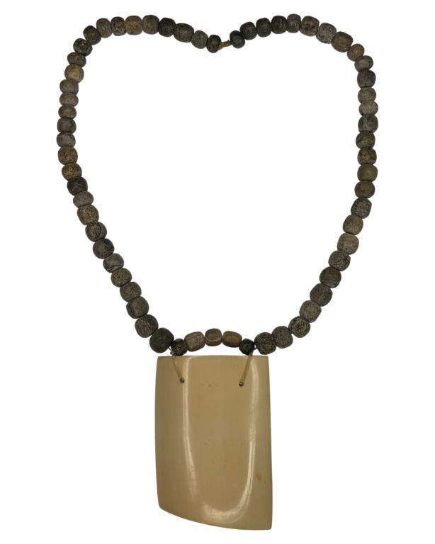 Fossilized Mastodon Beads & Tusk Necklace: Necklace made of Fossilized Mastodon Beads (25 mill. years old). The Pendant is part of a Mastodon Tusk (25 mill. years old). Measures 25" long. Good Condition.