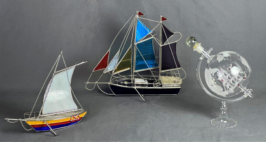 Stained Glass Sailboats & Ship in Globe Decanter: Two Stained Glass Sailboats and Boat in Etched Glass Globe Whiskey Decanter. Largest is 11" x 10" x 4". All are in good condition.