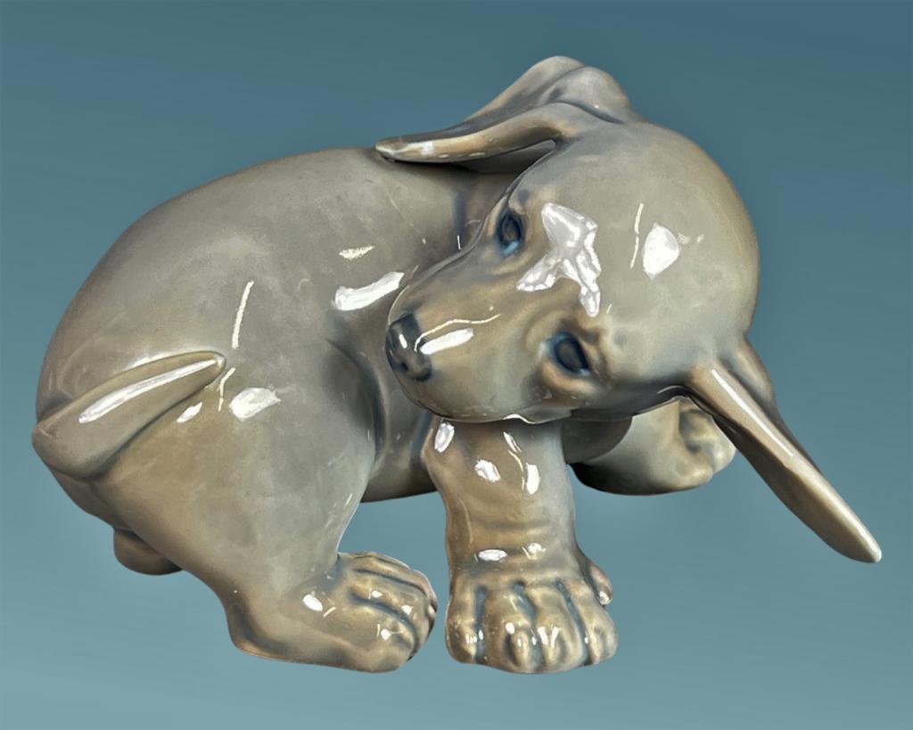 Royal Copenhagen Dachshund Dog Puppy Figurine: Royal Copenhagen Dachshund Dog Puppy Chasing his Tail Porcelain Figurine. 3" x 4 1/2". Good Condition.