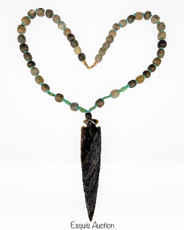 Fossilized Mastodon Bone & Turqoise Necklace: Fossilized Mastodon Bone (35 Mil. Yrs Old) and Turquoise Beads Neckalce with Stone Spear Head (age unknown). 28" long. Spear Head is 7" long. Good Condition.