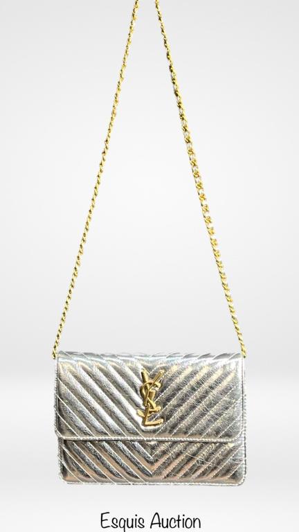 Yves Saint Laurent Silver Monogram Purse/ Bag/ Han: Yves Saint Laurent Silver Monogram Purse/ Bag. 7" x 10" good condition. READ BEFORE BIDDING: Esquis Auction does not have specialists on designer purses and handbags and we can not guarantee authentic