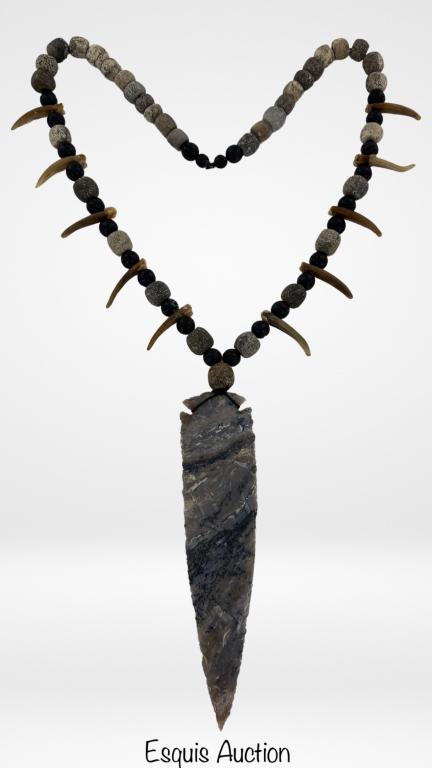 Fossilized Necklace w/ Mastodon Bone & Stone Spear: Necklace made of Fossilized Lava Beads, Mastodon Bone Carved Beads and American Badger Teeth. The Pendant is Stone Spear (age unknown). Necklace is 28" long, spear is 7" x 1 3/4". Good Condition.