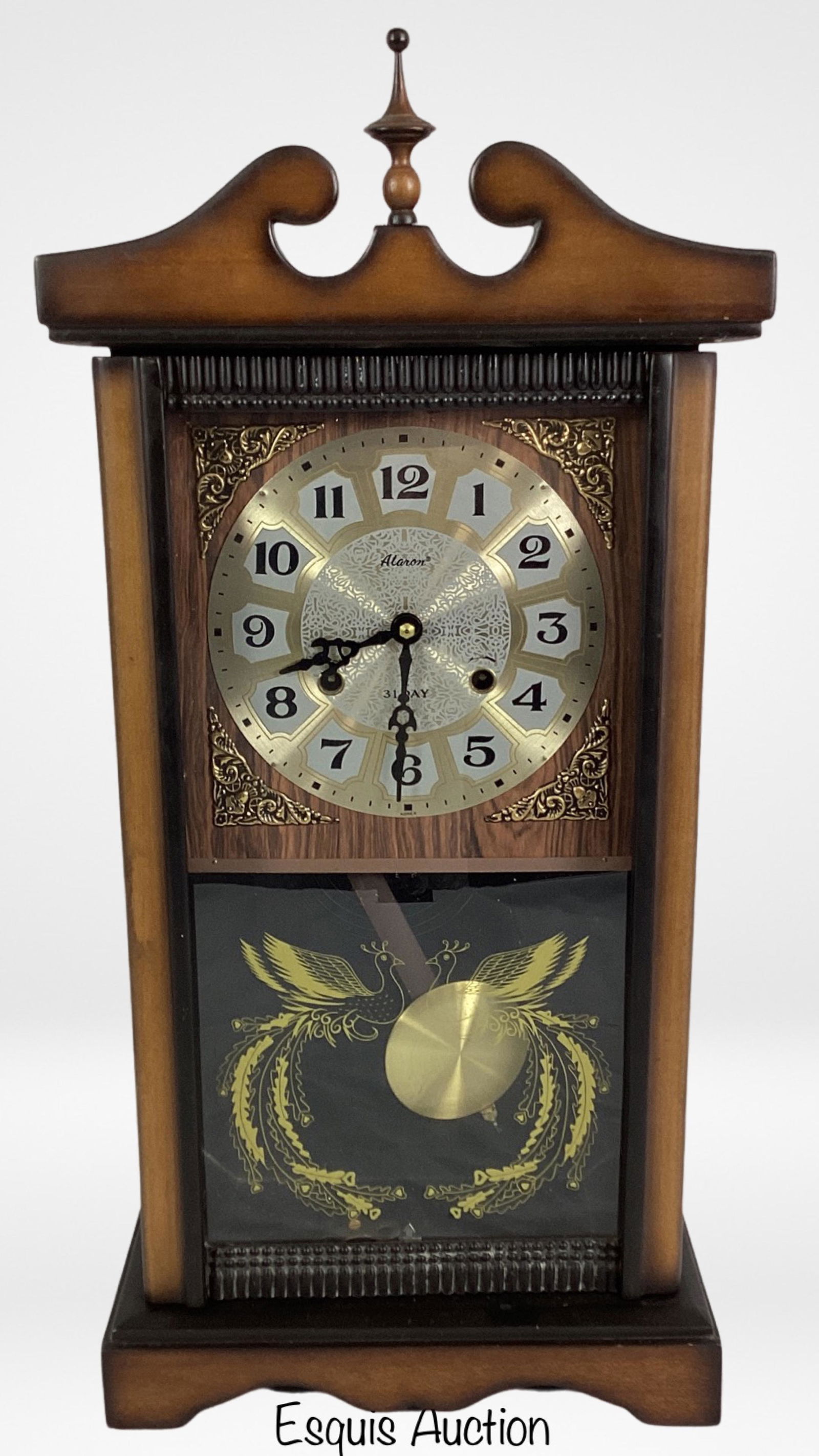 Alaron 31 Days Wall Clock in Wooden Case: Alaron 31 Days Wall Clock in Wooden Case. 25x12x5. Good condition, winds up and runs, not tested over long period of time.