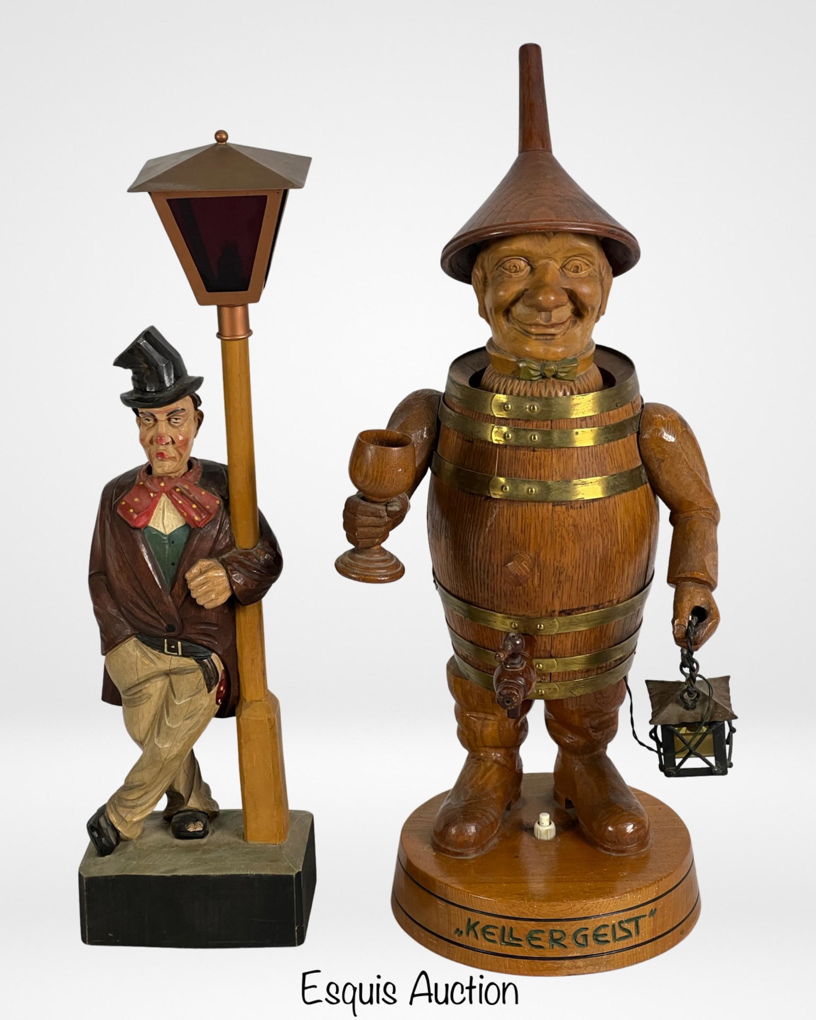 Kellergeist & Griesbaum Wood Carved Figurines: The first vintage German Kellergeist Wine wooden musical advertising figure is a charming and whimsical piece from the 1950s. Made in Germany, it features a wooden man in a wine barrel, standing at a 