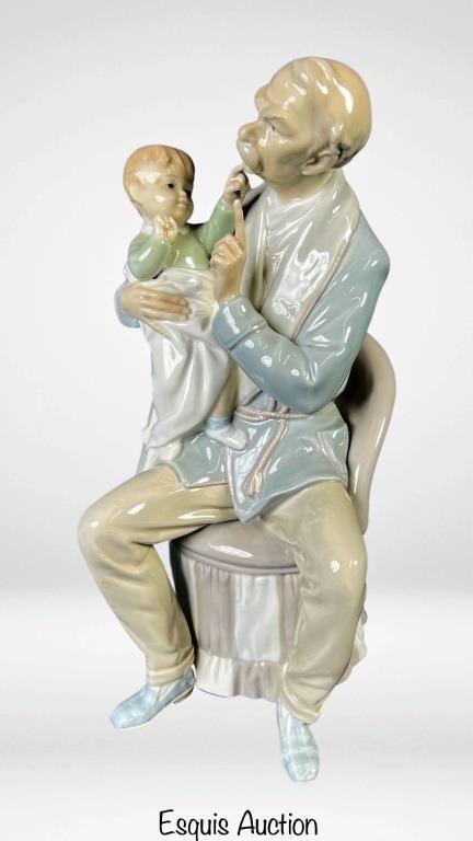 Lladro "The Grandfather with Baby" 4654 Figurine: The Lladro "The Grandfather" 4654 porcelain figurine is a remarkable piece that captures the essence of wisdom and paternal warmth. Standing at 12" tall, this figurine depicts a loving grandfather wit