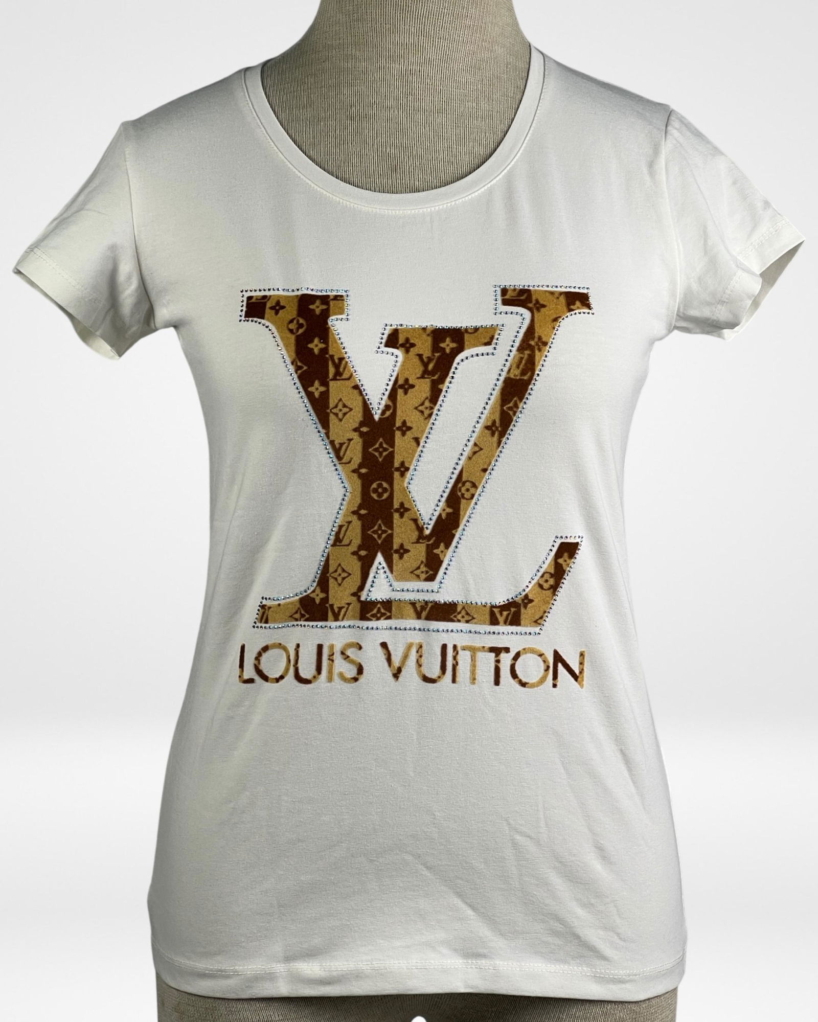 Louis Vuitton Lady's White T-Shirt - Large LV Logo: This Louis Vuitton Lady's White T-Shirt features a large "LV" signature logo prominently displayed on the front. The shirt is in mint/near mint condition, without tags. Crafted with attention to detai