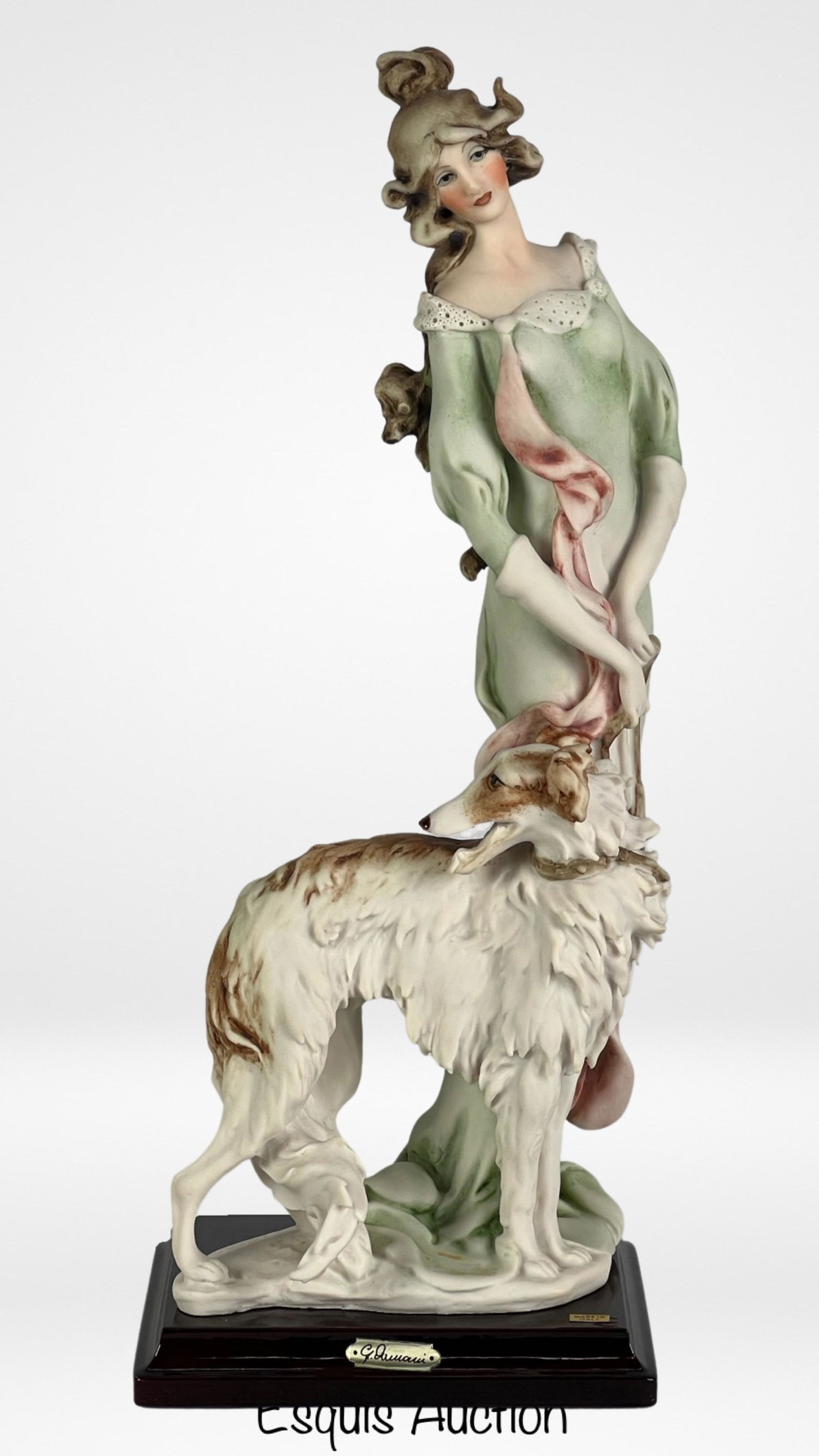 Giuseppe Armani- Lady with Borzoi Figurine: Step into the world of elegance and grace with Giuseppe Armani's "Lady with Borzoi" (Model-952/C) handcrafted figurine. Standing tall at 14 1/2", this exquisite masterpiece captures the essence of poi