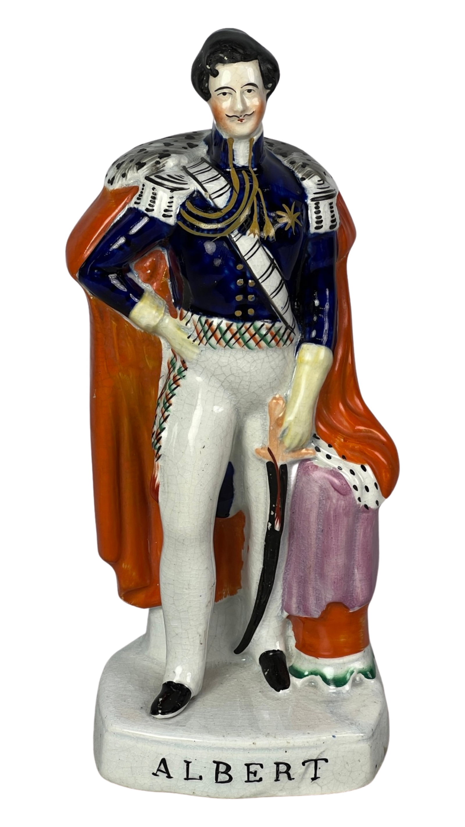 Antique Staffordshire Prince Albert Figure: This 10-inch tall antique Staffordshire figure is a remarkable portrayal of Prince Albert, adorned in a resplendent cloak and military uniform while elegantly grasping a sword in his left hand. The fi