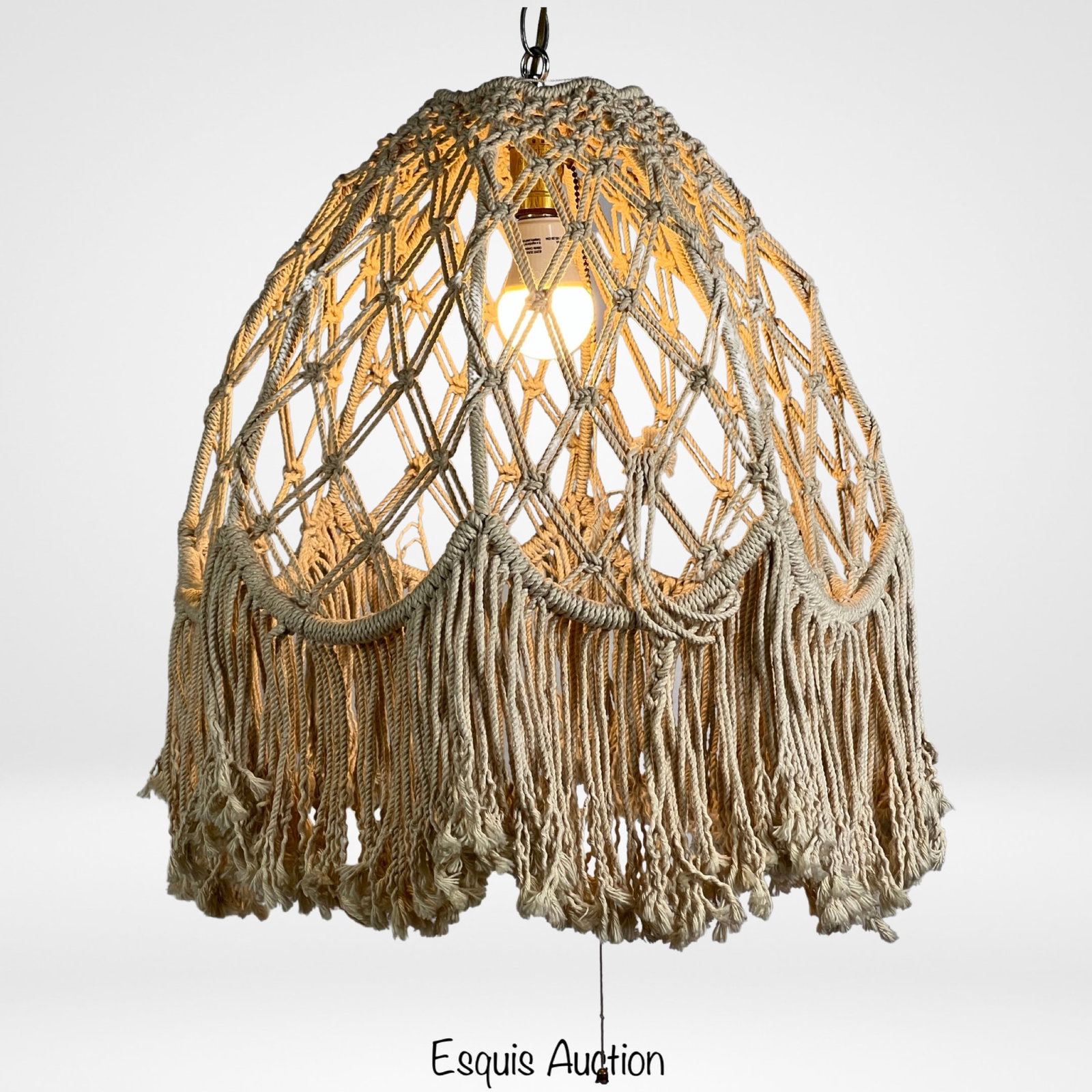 Vintage Hand Knotted Macrame Lamp Shade: Elevate your space with a touch of bohemian charm using this vintage hand-knotted macramÃ© lamp shade hanging pendant. Measuring 22" in length and 18" in diameter, this unique piece brings an artist