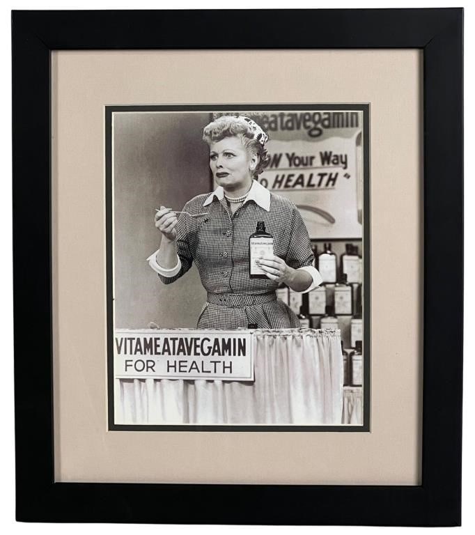 I Love Lucy- "Vitameatavegamin" Framed Photograph: Presenting a nostalgic piece of television history, the "I Love Lucy" "Vitameatavegamin" Framed Photograph. This framed photograph measures 16" x 14" and captures a memorable moment from the iconic sh