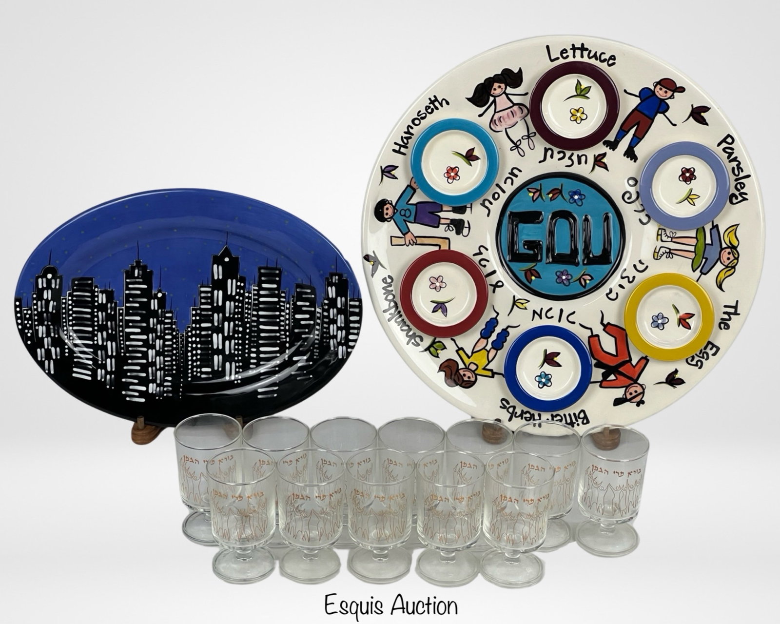 Jewish Judaica Wine Glasses & Passover Platter: The set of 12 Kiddush Wine Cups/Glasses by artist Nissan Engel, originating from France, is a collection of exquisite stemware that adds a touch of elegance to any special occasion, particularly durin