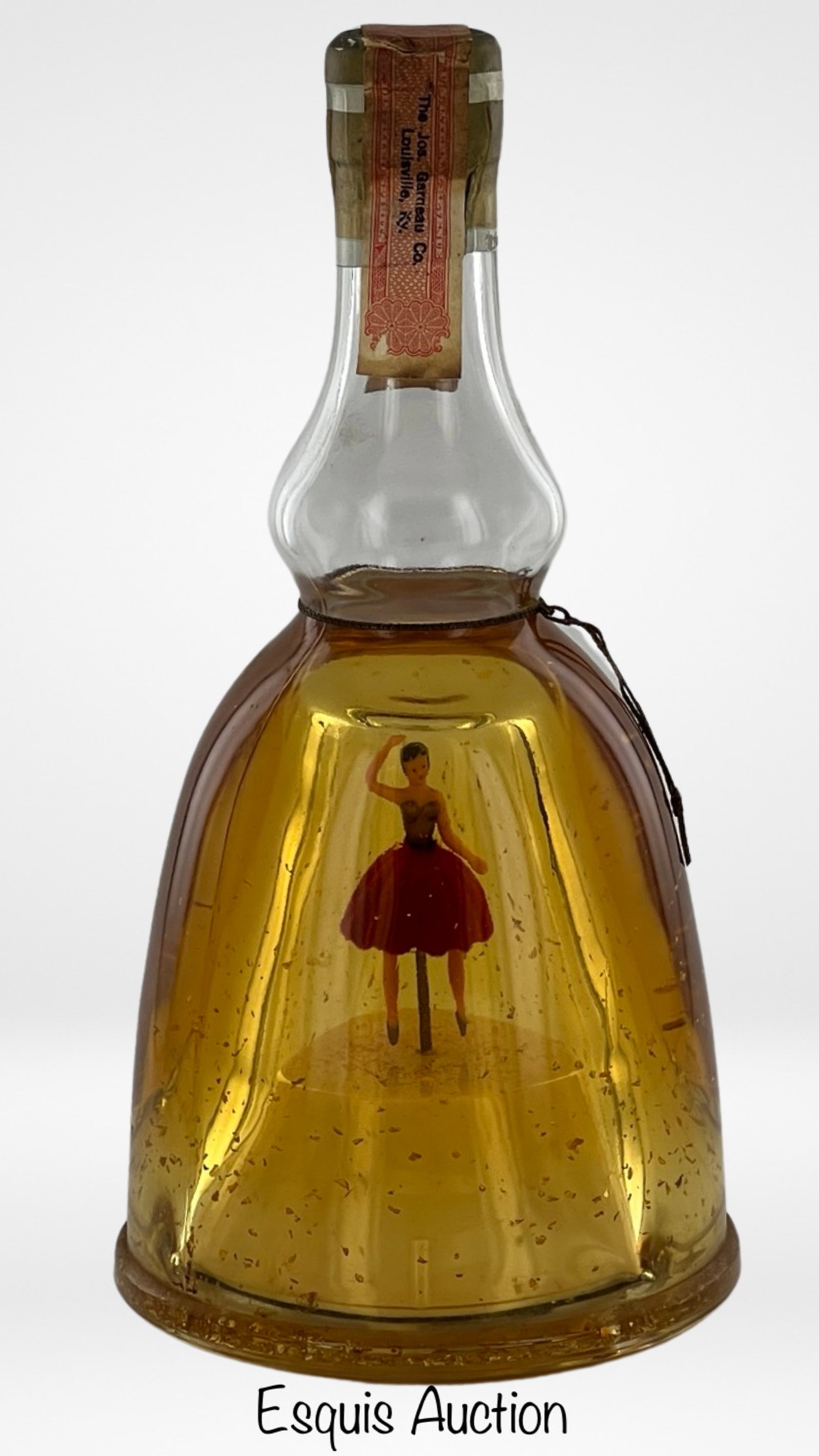 1950's Bols Ballerina Music Box Liquor Bottle Seal: The 1950's Lucas Bols Ballerina 18 Oz. Gold Creme De Menthe Music Box Liquor Bottle is a delightful blend of artistry and spirits. This vintage bottle is a true collector's gem. This particular bottle