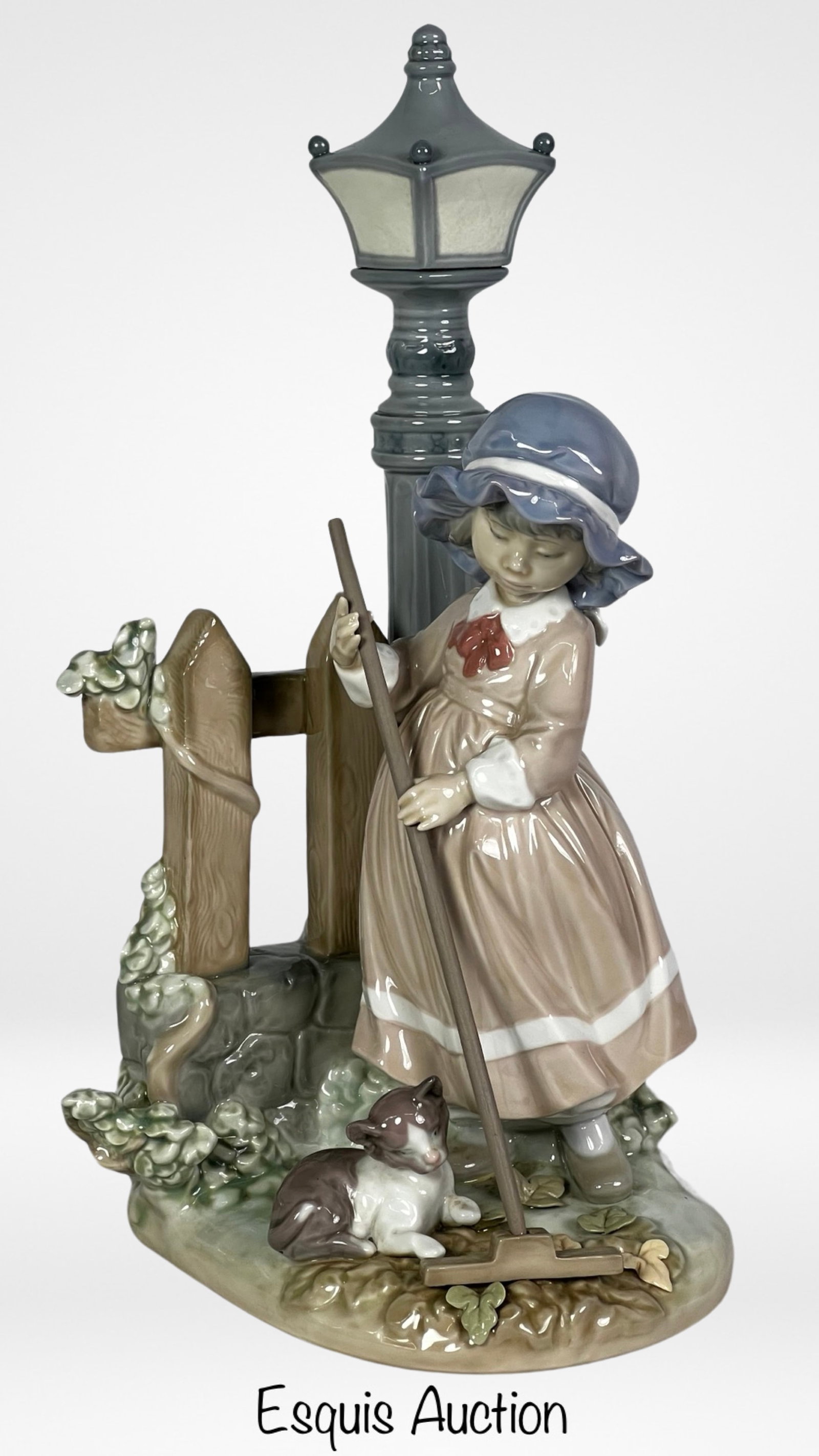 Lladro "Fall Clean Up" Porcelain Figurine #5286: Experience the beauty of autumn through the delicate craftsmanship of Lladro with the "Fall Clean Up" Porcelain Figurine #5286. This exquisite piece stands 13 inches tall, making it a stunning centerp