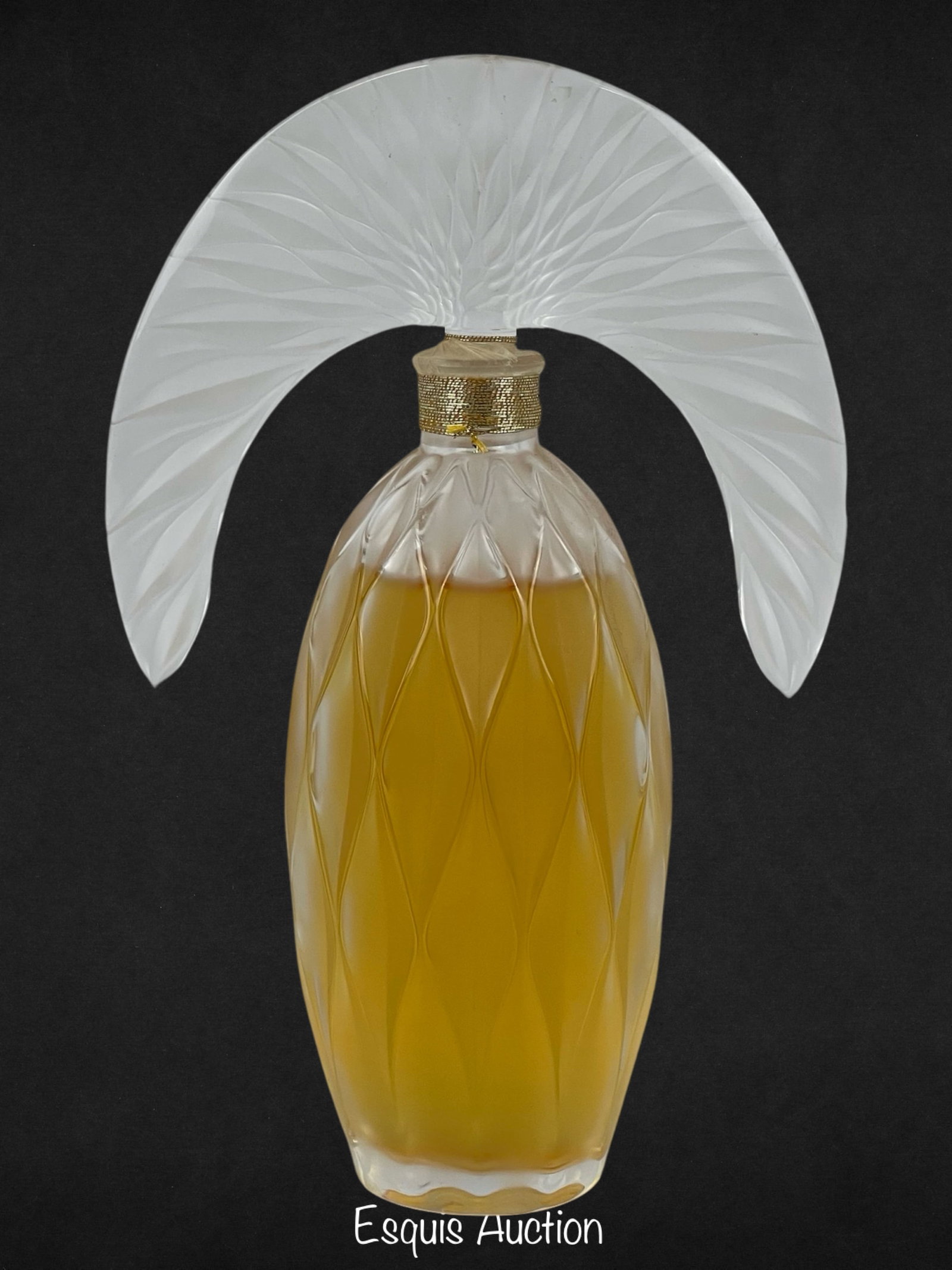 "Commedia de Lalique" 2007 Crystal Perfume Bottle: The Lalique 2007 Limited Edition Art Crystal "Commedia de Lalique" Perfume Bottle is a distinguished and collectible piece. This art crystal perfume bottle, part of a limited edition collection, featu