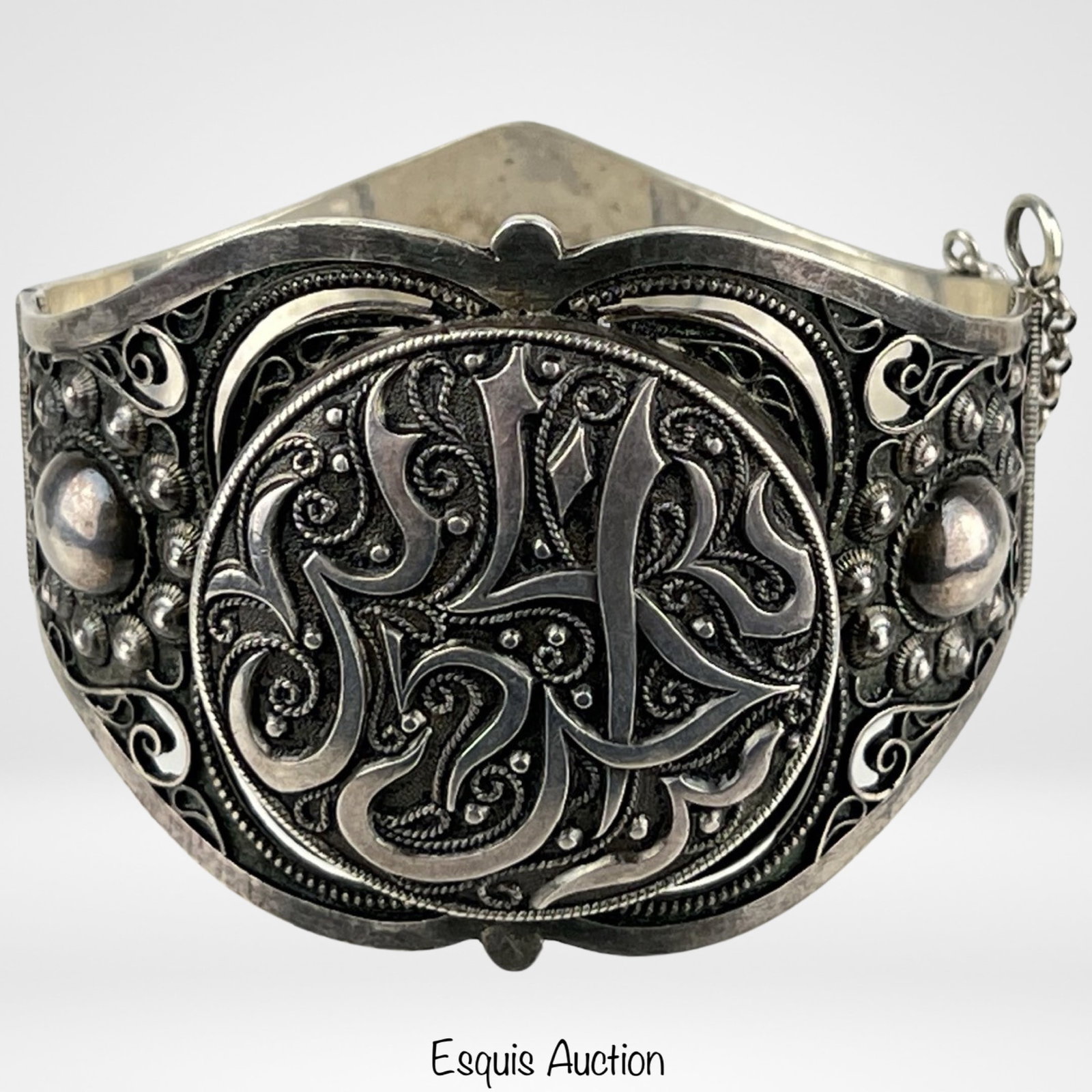 Arabic Calligraphy Sterling Silver Bracelet: Drape yourself in the intricate beauty of this Vintage Tunisian Sterling Silver Bracelet adorned with Arabic calligraphy. The bracelet, measuring a delicate 2 3/4" x 2 1/2" x 2", is a testament to the