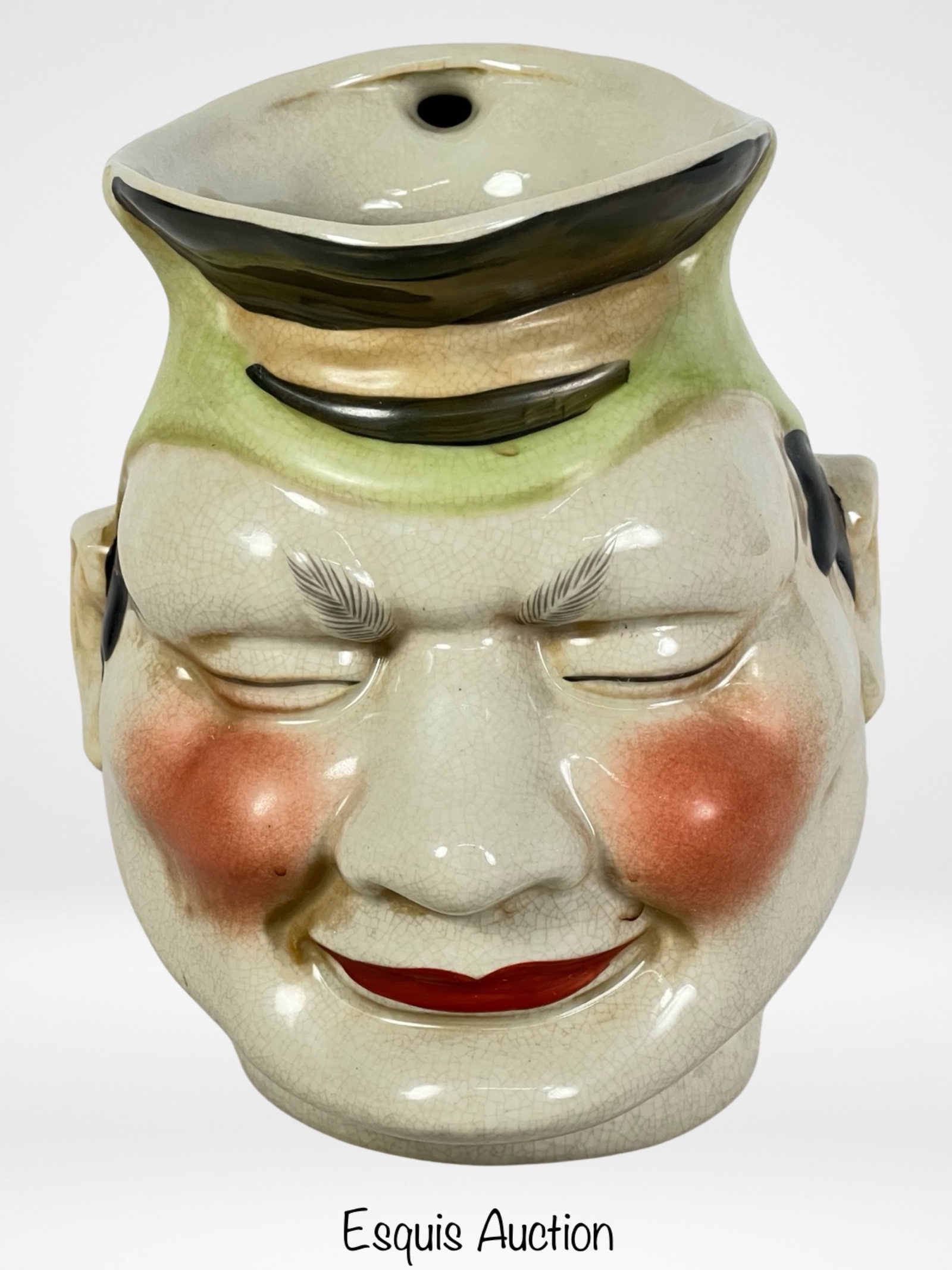 Majolica Sarreguemines Jolly Rotund Character Jug: Transport yourself back to the 19th century with this charming Majolica Sarreguemines Jolly Rotund Character Jug Pitcher. Standing at a height of 7 1/2 inches, this delightful piece exudes whimsy and 